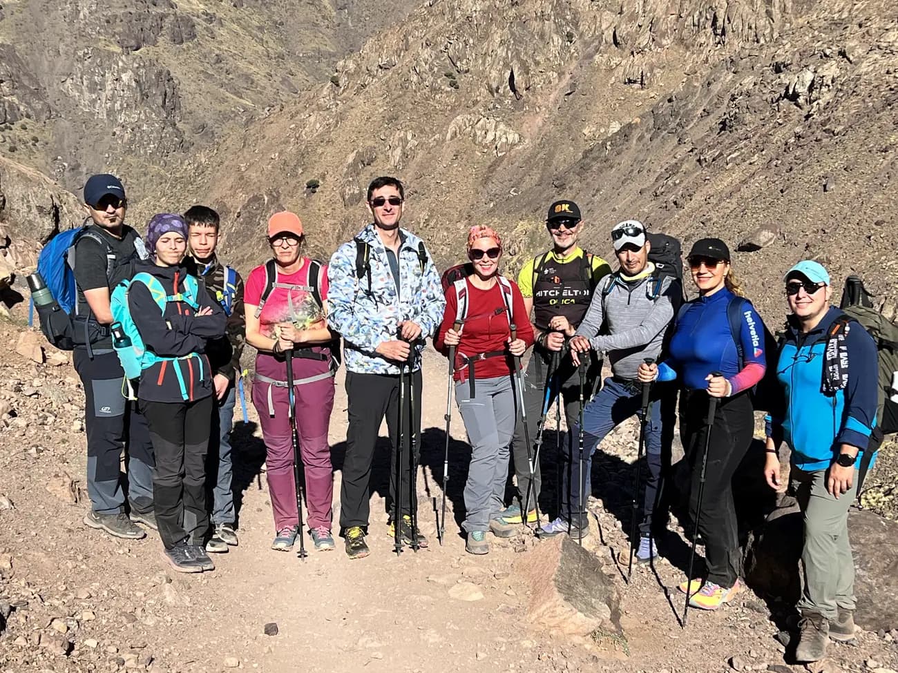 A guide and mule team carrying trekking kit up a High Atlas trail